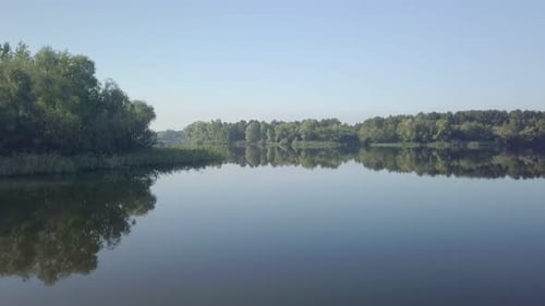 Picturesque Aerial View of Lake and Forest, Drone Is Moving Over Water Surface
