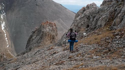 Hiker Ascends Rocky Mountain Trail