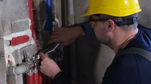 A Plumber Installs Heating in a New House