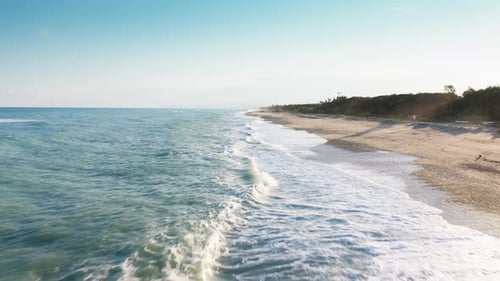 Dolly Out on the Surface of the Stormy Ocean Near the Beach