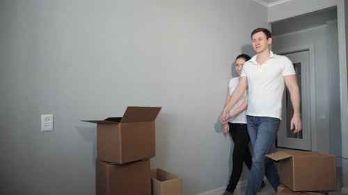 Couple Moving Into New Home with Cardboard Boxes