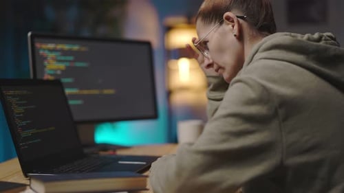Woman Typing Code Late at Night