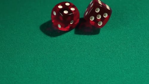 Macro view of red dice falling on green table, playing game at the Vegas casino