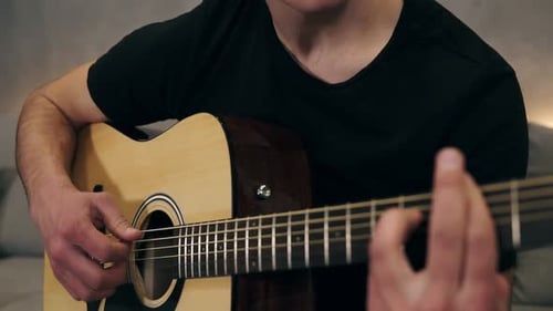 Man Playing Acoustic Guitar Indoors