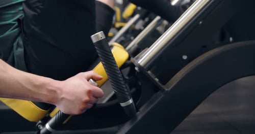 A Young Pumped Up Athlete Does Another Leg Exercise In The Gym In Preparation For Competition.