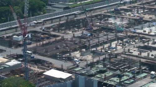 Large construction site with heavy construction machinery in metropolis