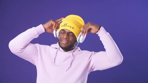 Man Listening to Music with Headphones in Studio