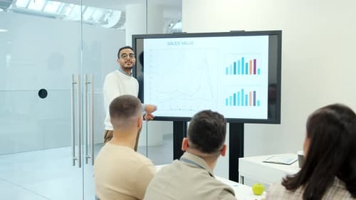 Arab Man Business Expert Speaking About Sales Value Using Digital Screen in Office
