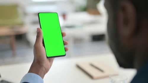 Businessman Using Smartphone with Green Chroma Key Screen