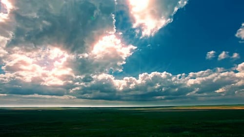 4K green field and cloudy sky