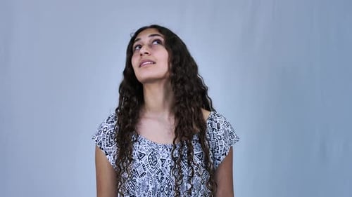 Girl with Curly Hair Looks Upwards