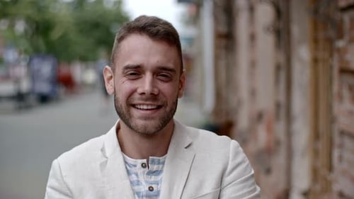 Smiling Man Wearing a Blazer Standing on Sidewalk