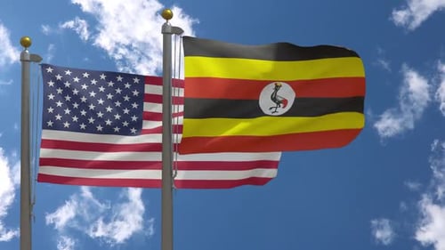 American And Ugandan Flags Waving In Blue Sky