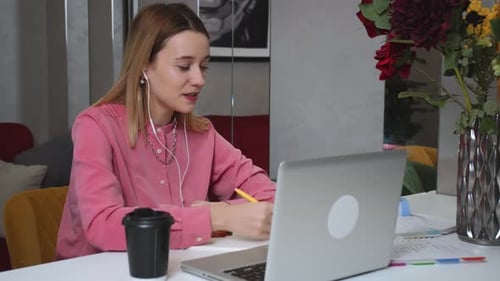 Young Woman Working at Home with Laptop