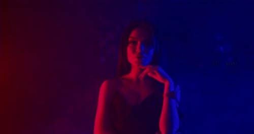 Glamorous Woman Posing with Red and Blue Lighting
