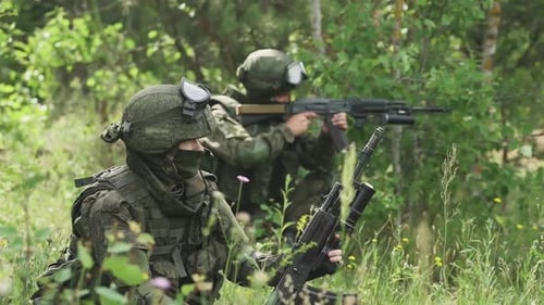 Un soldat en tenue de camouflage tire un lance-grenades avec un fusil d'assaut Action militaire contre Forest Soldiers
