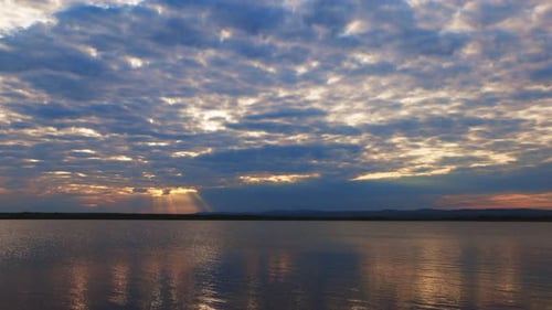 Black Sea with Cool Water Extends Beyond the Horizon Under a Sky with Clouds and a Dawn Sun