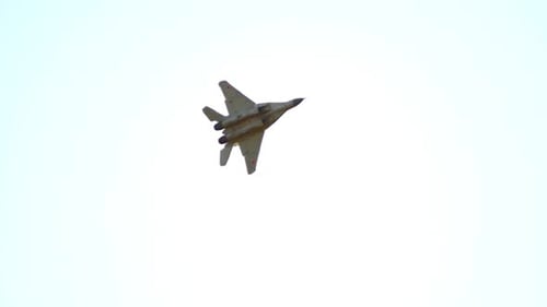 Fighter Jet Flying Against Bright Blue Sky