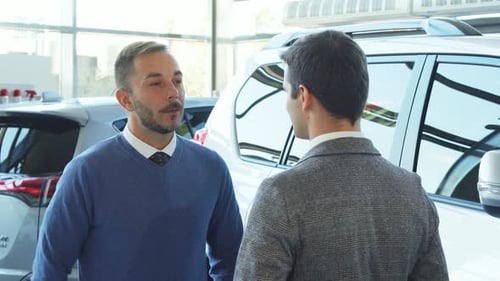 Businessmen Meeting and Shaking Hands at Car Dealership