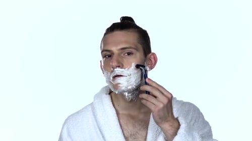 Young Adult Man Shaving his Face
