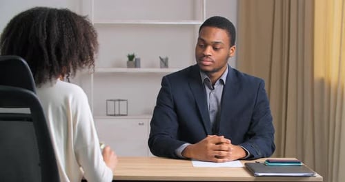 Woman Handing Businessman Cash at Office Desk