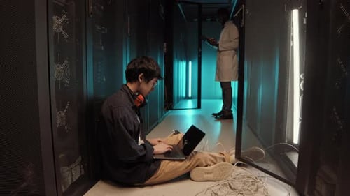Technicians Working in Modern Server Room