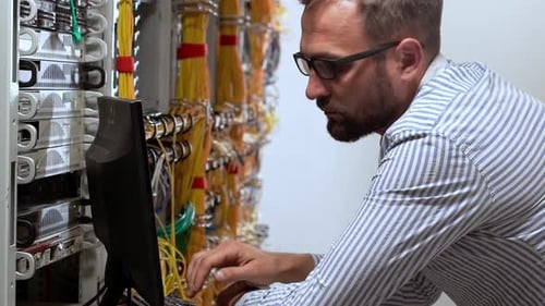 Man Working in Server Room Celebrates Success