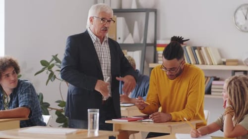 Teacher Explaining Lesson to Young Adult Students