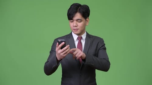Young Man Using Smartphone, Looking Surprised