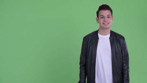 Young Adult Gesturing and Smiling on Green Background