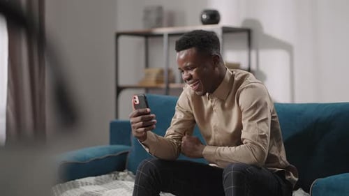 Young Adult Talking on Phone Video Call Indoors