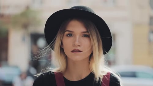 Blonde Woman with Hat Looking Confidently at Camera