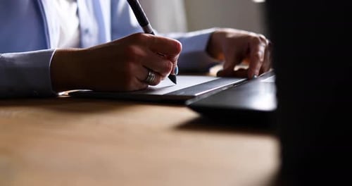Woman Using Graphics Tablet with Pen at Desk