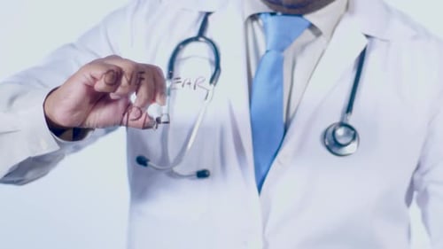 Doctor Writes One Year Plan on Clear Surface