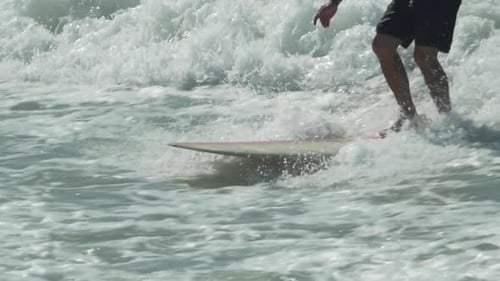 Surfer Rides Wave in Ocean