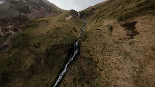 Fast FPV Drone Shot Up Along the Mountain Dew Towards to the Big Waterfall