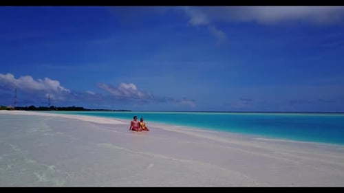 Man and lady engaged on tranquil sea view beach time by blue green water with white sand background