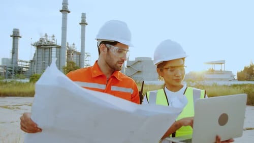 Engineers Review Plans at Industrial Plant