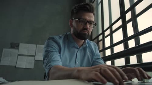 Caucasian Man Is Working on Laptop Computer at Style Loft Office