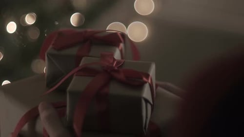 Christmas Gifts Stacked in Warm, Twinkling Lighting