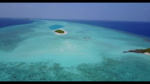 Aerial drone shot seascape of luxury coastline beach holiday by blue green water with white sandy ba