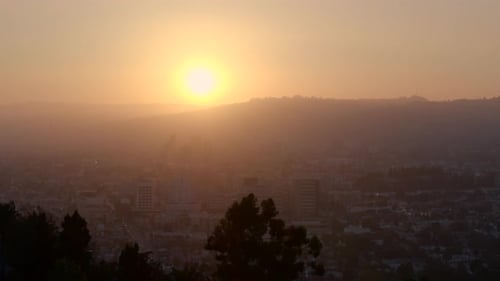 Aerial of bright sunset light over cityscape