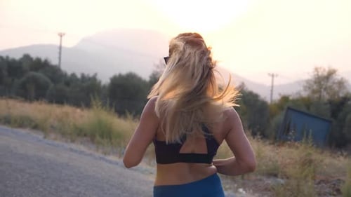 Young Woman Training for Marathon Run Outdoor. Sporty Girl Jogging in Country Road. Healthy Active