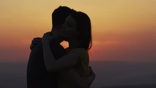 Loving Couple Embrace in Silhouette at Sunset