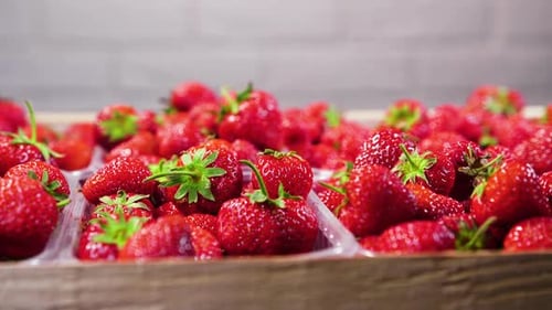 Vibrant Strawberries Displayed in a Wooden Crate