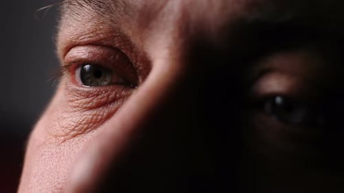 Depressed Sad Mature Man's Eyes in The Dark. Depressed Gaze