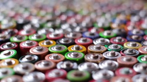 Large Pile of Colorful Batteries Close Up