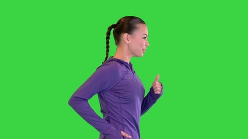 Female Runner in Sporty Outfit Jogging on a Green Screen Chroma Key