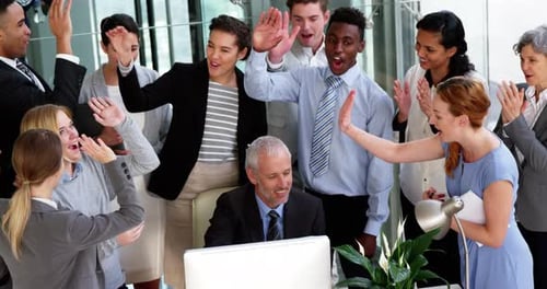 Business people giving a high five to each other