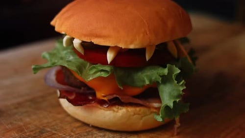 Burger Close-Up with Lettuce, Tomato, Cheese, and Bacon
